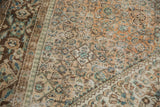 Distressed vintage Hamadan carpet detail, showing Herati pattern in beige, brown, and dusty green.