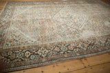 Distressed vintage Hamadan rug corner with faded chocolate brown, dusty green patterns.