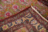The hand-knotted foundation and rust arabesque border of a vintage Farahan Sarouk rug.