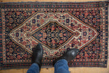 Vintage Senneh rug detail with complex Herati and stepped patterns in navy, ivory, blush.
