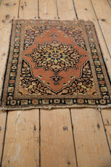 Vintage Tabriz rug's central medallion with tiered leaves and budded finials in rust, charcoal, and gold.