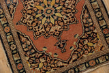 Corner detail of vintage Persian Tabriz rug, showing serpent border, pale rust field, and even pile wear.