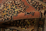 Vintage Tabriz rug's worn rust pile showing subtle foundation threads and patterned border.
