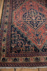 Vintage Senneh rug showcasing geometric floral Herati motif in madder root, navy, and ivory.