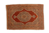 Vintage Tabriz rug with a rust starburst medallion, silver floral details, and sand-colored spandrels.