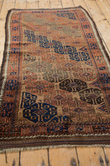 Angled view of an antique Belouch rug runner, highlighting its diagonal flow of geometric gul motifs.