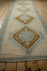 Distressed fringed end of the vintage Oushak rug in ivory and slate.