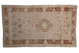 Distressed vintage Oushak rug, pale blush field, copper medallion and floral vinery, 4'6