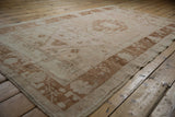 Vintage Distressed Oushak rug: pale blush, antique ivory, copper floral border with even wear.