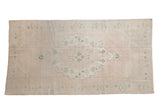 Distressed Oushak runner with a stepped central medallion in soft blush, ivory, and dusty ocean green.