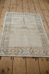 Distressed Vintage Oushak rug, bottom cartouche border in muted ivory and soft green.