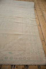 Textured pile of vintage distressed Oushak rug with even wear and subtle pale green-blue.