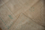 Vintage Oushak rug's hand-knotted foundation and distressed pile with pale ocean green patterns.