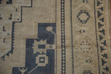 Vintage Distressed Oushak carpet: geometric motifs in antique ivory, dusty navy, pale seafoam green, and intact side selvage.