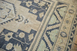 Distressed Oushak rug with dusty navy and seafoam green geometric patterns.