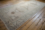 Distressed vintage Oushak runner with geometric guls, pale blue lines, and aged ivory-beige tones.