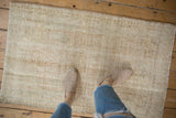 Distressed hand-knotted Oushak rug pile with subtle patterns in beige and dusty sea foam green.