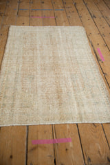 Vintage distressed Oushak rug's textured pile and subtle designs in muted beige and sea foam.