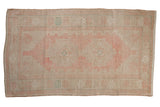 Vintage Distressed Oushak rug with stepped medallion, abrashes, in faded blush pink and pale turquoise.