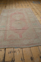 Vintage Oushak rug displaying soft blush pink and pale ocean green blue tones.