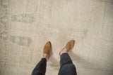 Distressed Oushak runner showing decorative pale green pattern, subtle abrash, and worn texture.