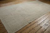 Distressed Oushak runner with muted beige tones, faint rose, and green abrash texture.