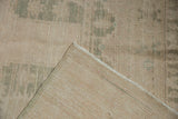 Distressed Oushak rug pile with mostly even wear and its tightly woven foundation.