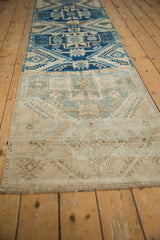 Distressed Oushak runner pile, showing even wear and muted beige, pale dusty teal geometric patterns.