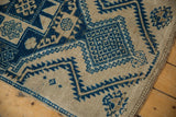 Textural close-up of a vintage Oushak rug's distressed pile and blue ram's horn design.