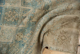 Textured pile of a vintage distressed Oushak runner, highlighting beige and pale dusty teal geometric motifs.