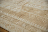 Distressed Oushak carpet with short, even pile texture and time-softened ivory and beige geometric motifs.