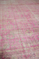 Textured surface of distressed Sivas carpet showing hot pink fuchsia pile and visible foundation.