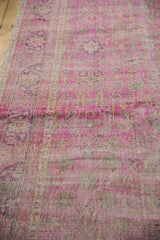 Hot pink fuchsia floral vinery and aubergine tones in the distressed Sivas pile.