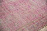 Vibrant hot pink fuchsia Sivas carpet, highlighting its distressed texture and faded floral pattern.