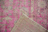 Distressed hot pink fuchsia pile of a vintage Sivas carpet, revealing its foundation.