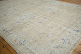 Distressed vintage Sivas carpet, worn ivory pile with faded cobalt blue floral vinery.