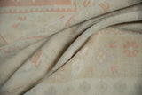 Distressed pile texture of a vintage Oushak rug with faded pink grapefruit and pale slate patterns.