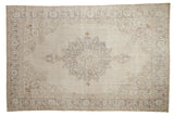 Distressed hand-knotted Turkish Sparta rug, antique ivory field, silver medallion, floral border.
