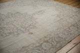 Distressed vintage Sparta carpet with faded floral palmette border pattern.