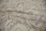Distressed vintage Sparta rug pile with soft silver, ivory, and coffee brown hues.
