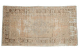 Distressed vintage Oushak rug, faded beige and silver geometric medallion with mostly even wear.