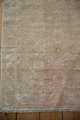Distressed vintage Oushak runner's textured pile, showing wear, foundation, and fringe.