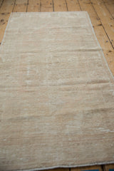 Distressed Oushak rug texture, showing mostly even wear to knot heads and visible foundation.