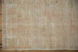 Vintage distressed Oushak rug texture with ivory and beige pile wear, revealing foundation and selvage.