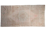 Distressed Oushak runner with faded blush, beige, and pale turquoise stepped medallion. 4'6