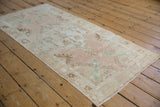 Distressed Turkish Oushak runner detail: worn dusty rose and ivory patterns with exposed foundation.