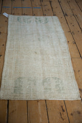 Reverse of the Vintage Distressed Oushak rug, showing hand-knotted foundation and faint green painted numbers.