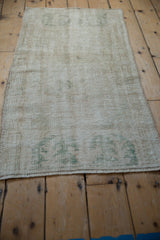 Textured worn pile and pale ocean green hues on a vintage distressed Oushak runner with fringe.