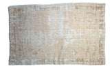 Distressed vintage Oushak rug, ivory and sand tones with faded geometric floral designs.