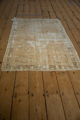 Distressed Oushak rug fringe and geometric border showing wear and foundation.
